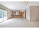 Open concept living room offering tile flooring, sliding glass doors, and kitchen view at 2130 Frontier Ln, Franktown, CO 80116