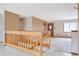 Bright and airy living room featuring neutral walls, white carpets, and a wooden staircase at 2130 Frontier Ln, Franktown, CO 80116