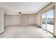 Spacious living room with sliding glass door and neutral decor at 2130 Frontier Ln, Franktown, CO 80116
