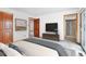 Main bedroom leading to bathroom and balcony access through doorways with a TV on the wall at 2130 Frontier Ln, Franktown, CO 80116