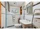 Bright, remodeled bathroom with tiled walls and floors, and a pedestal sink at 4364 Colorado 103, Idaho Springs, CO 80452