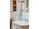 Close up of updated bathroom featuring a pedestal sink, mirror, and white towels at 4364 Colorado 103, Idaho Springs, CO 80452