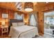 Wood-paneled bedroom with neutral tones and natural light for a warm, inviting feel at 4364 Colorado 103, Idaho Springs, CO 80452