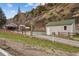 Property featuring multiple sheds, greenhouses and living spaces at 4364 Colorado 103, Idaho Springs, CO 80452