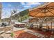 Outdoor patio with a hot tub, lounge chairs, and stone pathway leading to a serene mountain view at 4364 Colorado 103, Idaho Springs, CO 80452