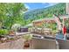 Inviting outdoor living space featuring a hot tub, comfortable seating, and a scenic mountain backdrop at 4364 Colorado 103, Idaho Springs, CO 80452