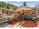 Cozy patio with stone accents, comfortable seating, and scenic views of the surrounding mountains and trees at 4364 Colorado 103, Idaho Springs, CO 80452
