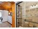 Stone-walled shower with glass doors is adjacent to a bedroom with wood details at 4364 Colorado 103, Idaho Springs, CO 80452