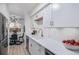 Updated kitchen features stainless steel appliances, quartz countertops, and view into dining area at 1060 S Parker Rd # 36, Denver, CO 80231