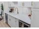This kitchen features modern white cabinets, a wine cooler, and new stainless-steel appliances at 1060 S Parker Rd # 36, Denver, CO 80231