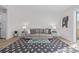 Bright living room featuring hardwood floors, area rug and a white painted brick accent wall at 1060 S Parker Rd # 36, Denver, CO 80231