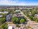 Expansive aerial view showcasing the city skyline, tree-lined streets and charming neighborhood at 2565 Champa St, Denver, CO 80205