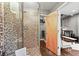 Beautiful bathroom with a tiled glass shower and adjacent closet at 2565 Champa St, Denver, CO 80205