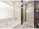 Bright bathroom with a soaking tub, sleek tiling, and a separate shower area at 2565 Champa St, Denver, CO 80205