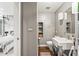 Modern half bathroom with stylish fixtures, neutral tones, and convenient shelving at 2565 Champa St, Denver, CO 80205