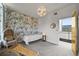 Bright bedroom featuring stylish wallpaper, a cozy chair, and access to a balcony at 2565 Champa St, Denver, CO 80205