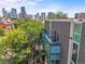 Brick building balconies overlooking a city skyline, featuring modern architecture and lush greenery at 2565 Champa St, Denver, CO 80205