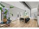 Bright dining room with a large wooden table, modern lighting, and plenty of natural light at 2565 Champa St, Denver, CO 80205