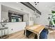 Bright dining room with hardwood floors, a modern chandelier, and an open view of the kitchen at 2565 Champa St, Denver, CO 80205