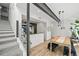 Bright dining room with hardwood floors, modern chandelier, and open layout to the kitchen at 2565 Champa St, Denver, CO 80205