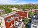 Stunning aerial view of the property showcasing a modern design with rooftop decks and beautiful landscaping at 2565 Champa St, Denver, CO 80205