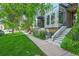 Charming home with green lawn and walkway leading to the front door at 2565 Champa St, Denver, CO 80205
