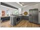 Open-concept kitchen featuring modern appliances and cabinetry with a view of the dining area at 2565 Champa St, Denver, CO 80205