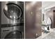 Modern stackable washer and dryer situated next to a bathroom with a vessel sink at 2565 Champa St, Denver, CO 80205