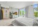 Bright main bedroom with neutral tones, large windows, and a decorative accent wall at 2565 Champa St, Denver, CO 80205