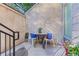 Cozy outdoor patio with mosaic table and chairs, surrounded by flowers and plants at 2565 Champa St, Denver, CO 80205