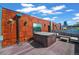 Rooftop deck featuring a hot tub, lounge seating and scenic views of the city skyline at 2565 Champa St, Denver, CO 80205