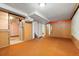Spacious basement area with retro carpet, closet and hallway access at 7140 Avrum Dr, Denver, CO 80221