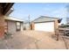 Paved driveway leading to a garage, shed and bench at 7140 Avrum Dr, Denver, CO 80221