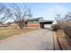 This cozy home boasts a covered carport, brick accents, and a well-maintained driveway at 7140 Avrum Dr, Denver, CO 80221