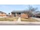 Charming brick home with a cozy front yard and covered entry at 7140 Avrum Dr, Denver, CO 80221