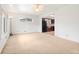 Bright living room with natural light and neutral carpet, seamlessly connected to the kitchen at 7140 Avrum Dr, Denver, CO 80221