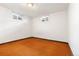 Empty room with orange carpet, white walls, and natural light from two windows at 7140 Avrum Dr, Denver, CO 80221