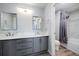 Bright bathroom showcasing double vanities, a toilet, and a shower-tub combo at 23405 E 5Th Pl # 201, Aurora, CO 80018