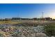 View of school buildings and parking lot, featuring natural landscaping in the foreground at 23405 E 5Th Pl # 201, Aurora, CO 80018