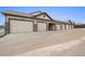 Row of garages featuring red brick accents and large driveways at 23405 E 5Th Pl # 201, Aurora, CO 80018