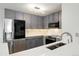 Modern kitchen with stainless steel appliances, grey cabinets, and white countertops at 23405 E 5Th Pl # 201, Aurora, CO 80018