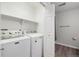 Laundry room features modern washer and dryer and access to bathroom at 23405 E 5Th Pl # 201, Aurora, CO 80018