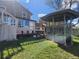 Backyard featuring a deck, sunroom, gazebo, and green grass at 812 S Ouray St, Aurora, CO 80017