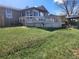 Backyard view with sunroom, deck, gazebo, and lush green lawn at 812 S Ouray St, Aurora, CO 80017