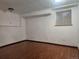 Unfinished basement with wood floor, white walls, and one window at 812 S Ouray St, Aurora, CO 80017