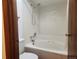 Clean bathroom featuring a shower and bathtub combo with white tile and neutral finishes at 812 S Ouray St, Aurora, CO 80017