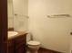 Bathroom with a wooden vanity, white sink, and a toilet with clear wall space at 812 S Ouray St, Aurora, CO 80017