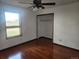 Bright bedroom with hardwood floors, ceiling fan, closet and a window showcasing scenic outdoor views at 812 S Ouray St, Aurora, CO 80017