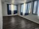 Bright bedroom with neutral walls, dark laminate flooring and large windows at 812 S Ouray St, Aurora, CO 80017