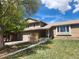 Charming two-story home with attached two car garage and brick and siding exterior on a lush lot at 812 S Ouray St, Aurora, CO 80017